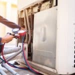 Temco hvac technician using a pressure guage