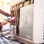 Temco hvac technician using a pressure guage